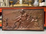 a bronze statue of a woman sitting on a table