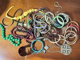 many bracelets and bracelets on a wooden table
