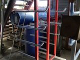 a picture of a room with a lot of pipes and a ladder