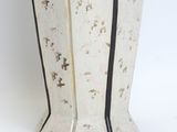 a white vase with a black stripe on it