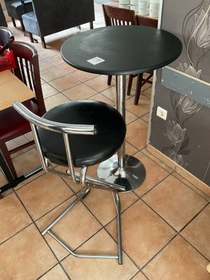 a black table and two chairs in a restaurant