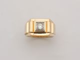 an 18k yellow gold ring with a princess cut diamond