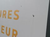 a sign on the side of a building stating that there is no parking