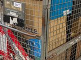 a metal cage filled with boxes and other items
