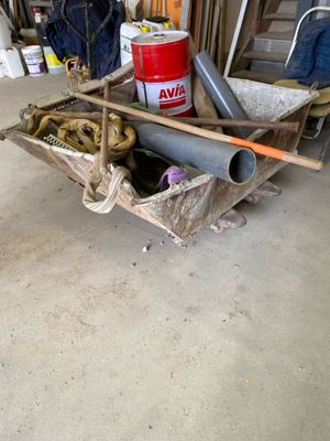 a wheelbarrow that is sitting in a garage filled with tools