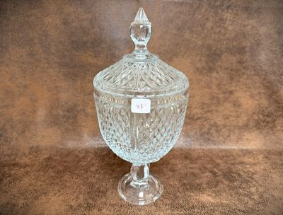 a clear glass jar with a lid on a table
