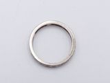 a close up of a silver ring on a white surface
