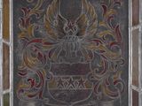 an old stained glass window with a coat of arms on it