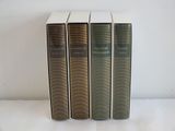 three books sitting on top of a white table next to each other
