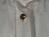 a close up of a white shirt with buttons on it