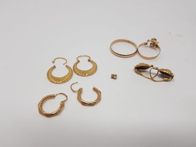 three pairs of gold hoop earrings and a pair of gold hoop earrings