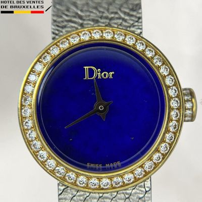 an image of a close up of a wrist watch with a blue dial