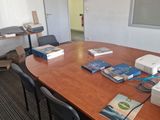 a table with a printer and several books on it