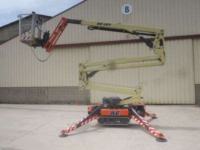 a picture of a man on a cherry picker in front of a building