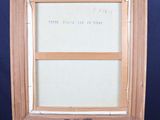 an old wooden easel with a picture frame on top of it