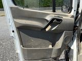 a white van with the door open sitting in a parking lot