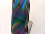 a close up of a phone on a stand on a white surface