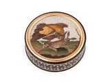 une image représentant une boîte ronde sur laquelle figurent un oiseau et un cerf