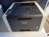 the printer is sitting on top of the table in the room