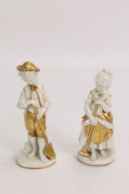 pair of porcelain figurines of a boy and a girl playing musical instruments