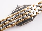 an image of a gold and silver watch on a white surface