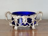 a blue glass bowl sitting on a wooden table