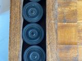 a wooden table with a chess board and cups in it
