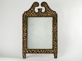 an animal print mirror with a wooden frame and a leopard print design