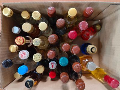many bottles of wine in a cardboard box on the floor