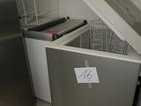 a silver refrigerator with a sign on it in a kitchen