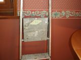 a ladder in the corner of a room next to a window