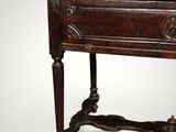 an old wooden table with a drawer on top of it