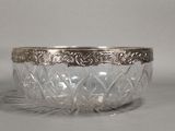 silver plated glass bowl with ornate design on the rim