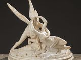 an image of a statue of a woman and a man on a rock