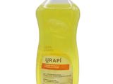 a yellow bottle of liquid with a white lid on a white surface