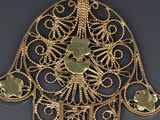 an image of a gold plated hamsa hand with four coins on it
