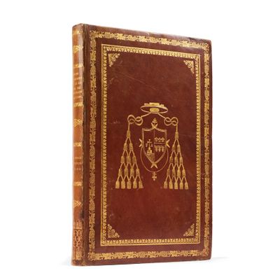 an old book with a coat of arms on the cover