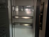 an open refrigerator that is sitting in a room