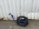 a hose that is sitting on the ground next to a wall