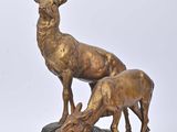statue of a stag and a baby stag on a rock