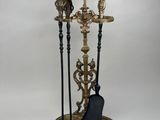 an image of a set of three candles and a broom on a stand