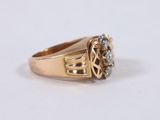 a close up of a gold ring with a diamond on it