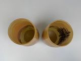 two cups that are sitting next to each other on a table