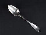 a spoon that is sitting on a black surface