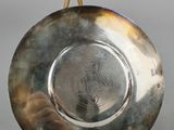 pair of silver plate on stand on grey background