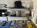 many dishes and pans on the shelves in the kitchen