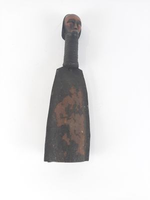 a small metal object on a white surface with a white background