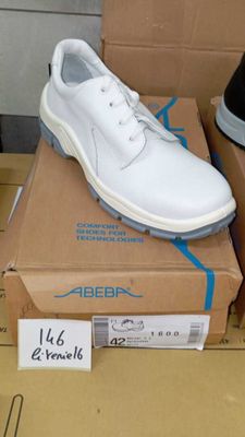 two pairs of shoes that are on top of a box