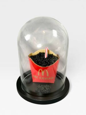 a mcdonald ' s cupcake under a glass dome on a table