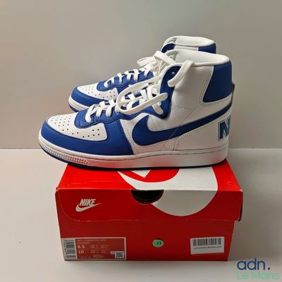 blue and white nike dunk high top sneakers on top of a red box